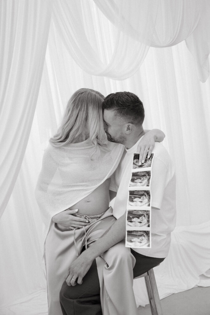 Photo of a couple expecting first baby in a studio in New York